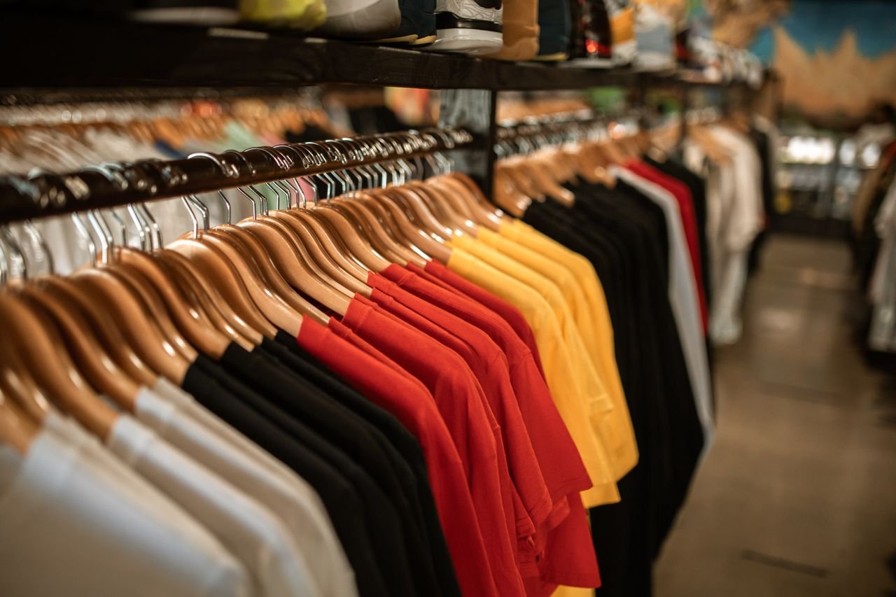 Mastering the First Impression: Your intriguing post title goes here Clothing store display with shirts hanging neatly on a rack indoors.